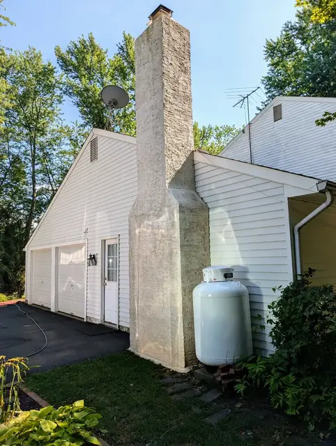 The same chimney and garage washed clean and bright